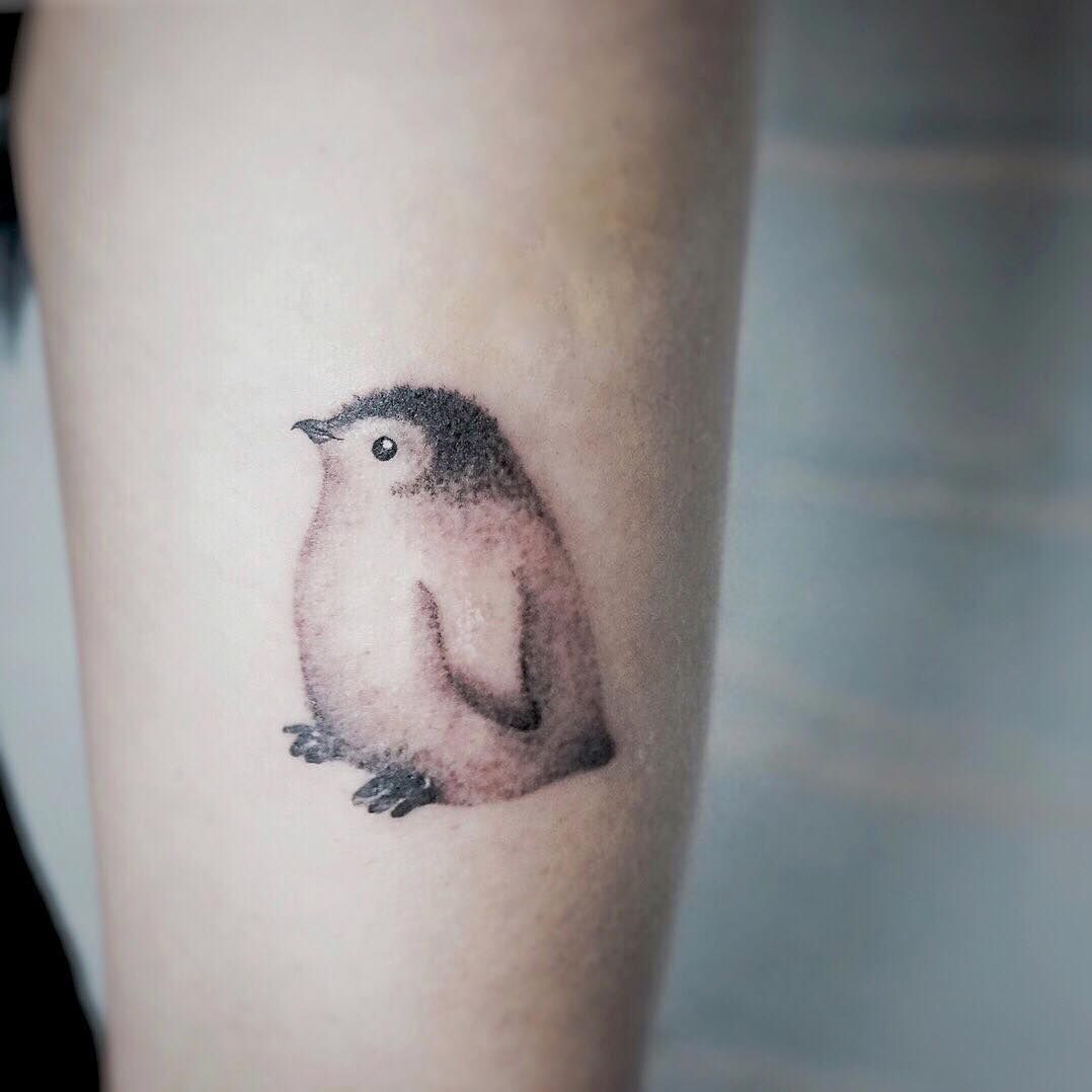 Cute penguin tattoo design on wrist and hand