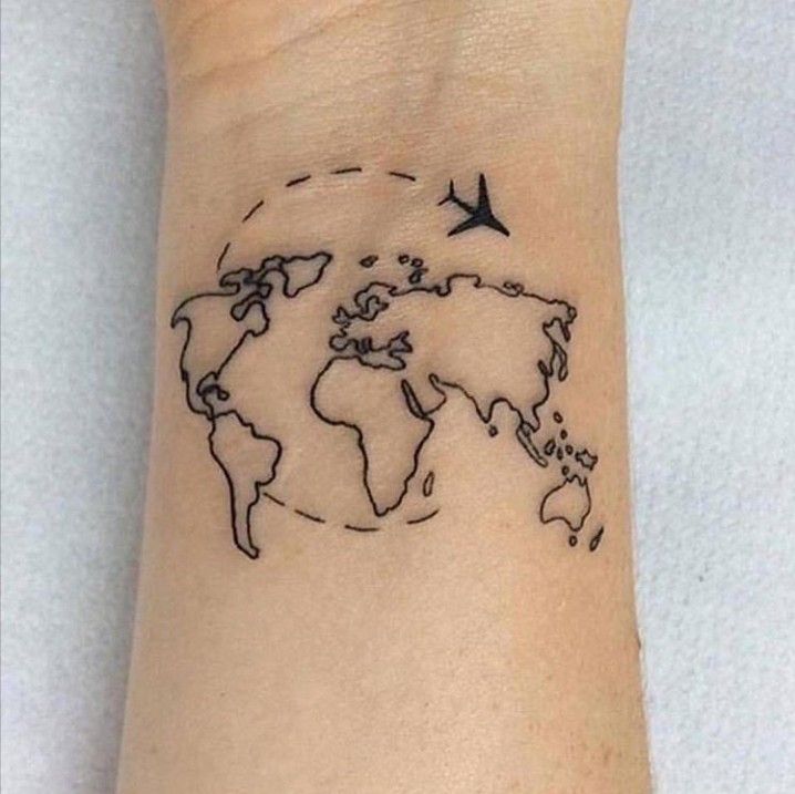 Tiny world map art tattoo on wrist and hand