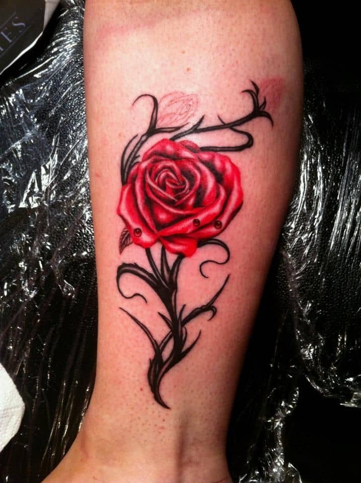 rose tattoo on hand and wrist
