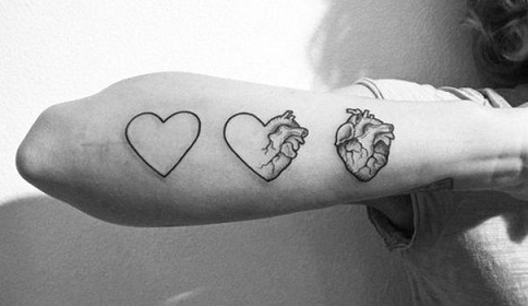 three-step heart tattoo design on hand and wrist